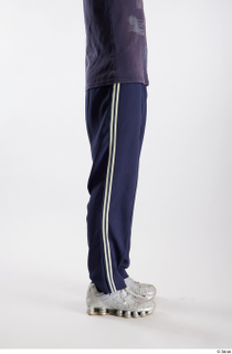 Urien  1 blue track pants dressed flexing leg side…